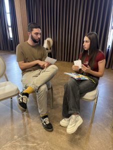 Dvoje učesnika razgovaraju i rade zadatke na radionici